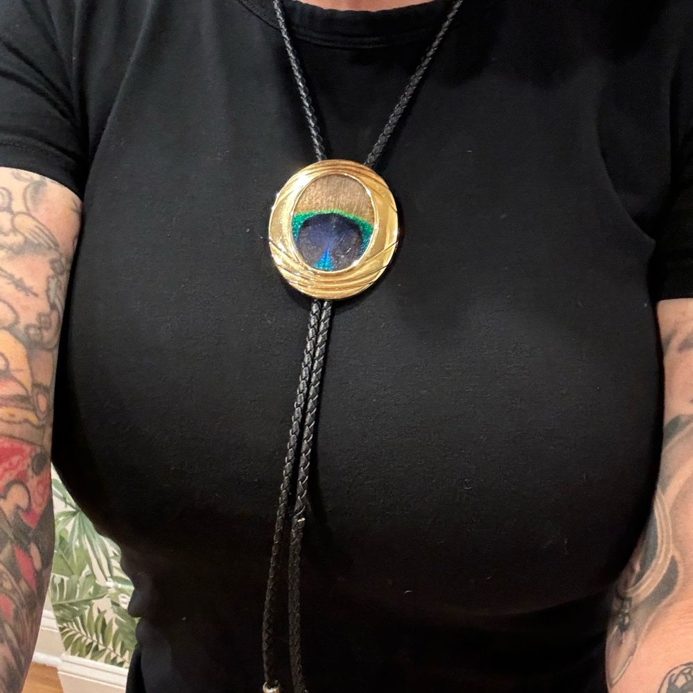 Peacock feather brass bolo
